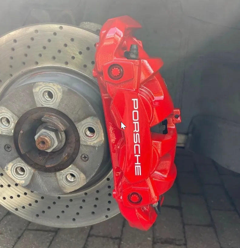 Porsche calipers — repaint in red with crisp wordmark.